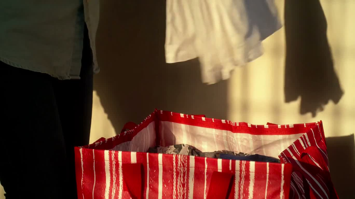 Sorting Clothes in Warm Light