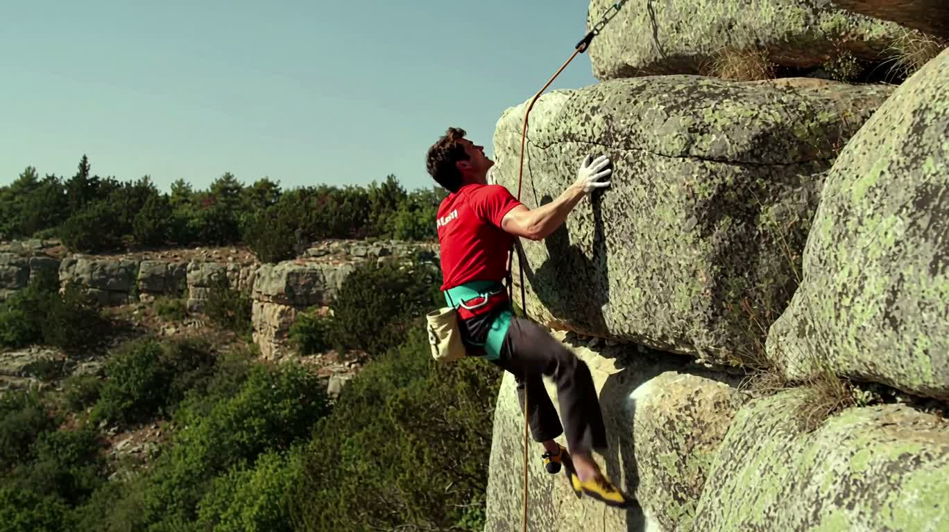 Thrilling Moment of Cliff Climbing