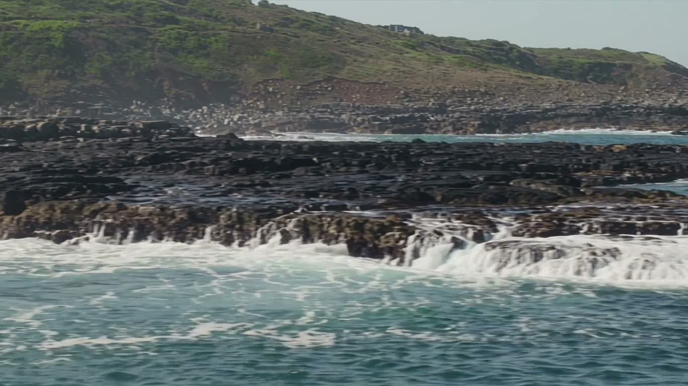 Waves Crashing Against Coastal Rocks